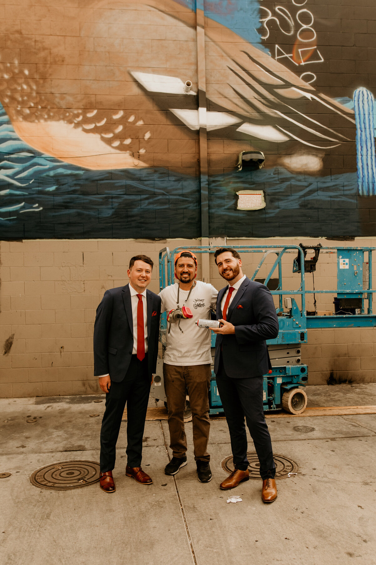 artist signing a spray can for grooms in downtown Albuquerque