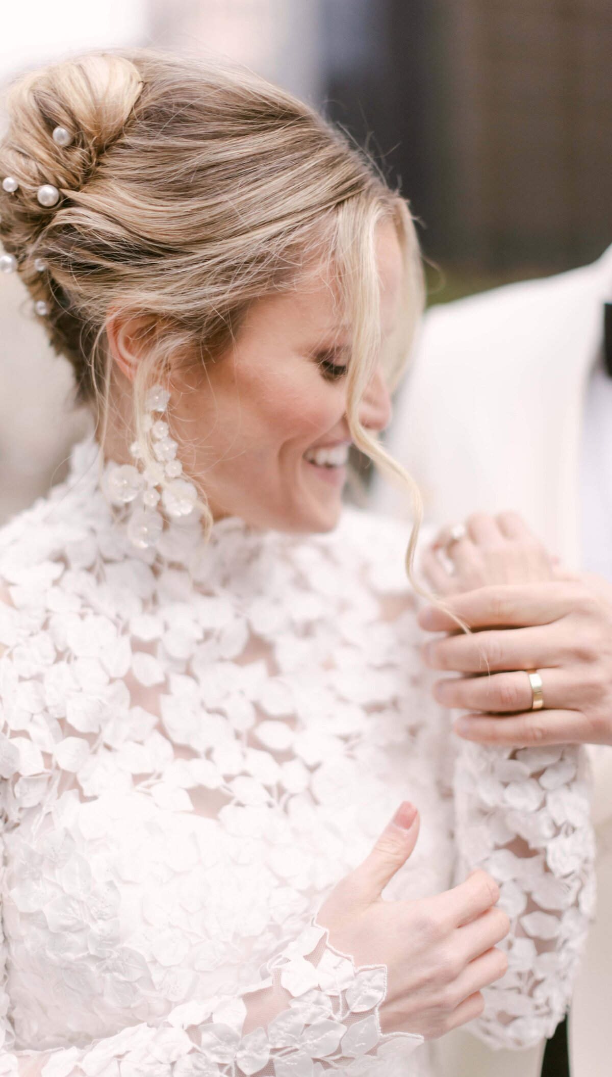 Groom holding his brides hand