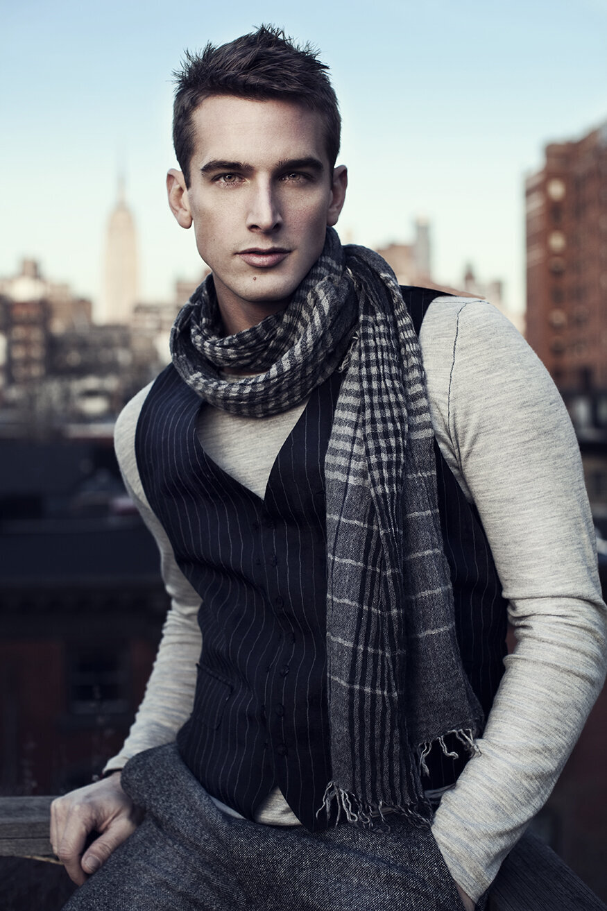 Moody portrait of Noah in a dark jacket with an intense expression, photographed by Ylva Erevall.