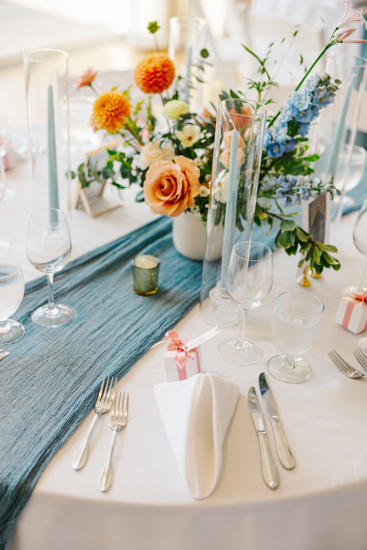 Wedding reception table decorated with colorful floral centerpiece