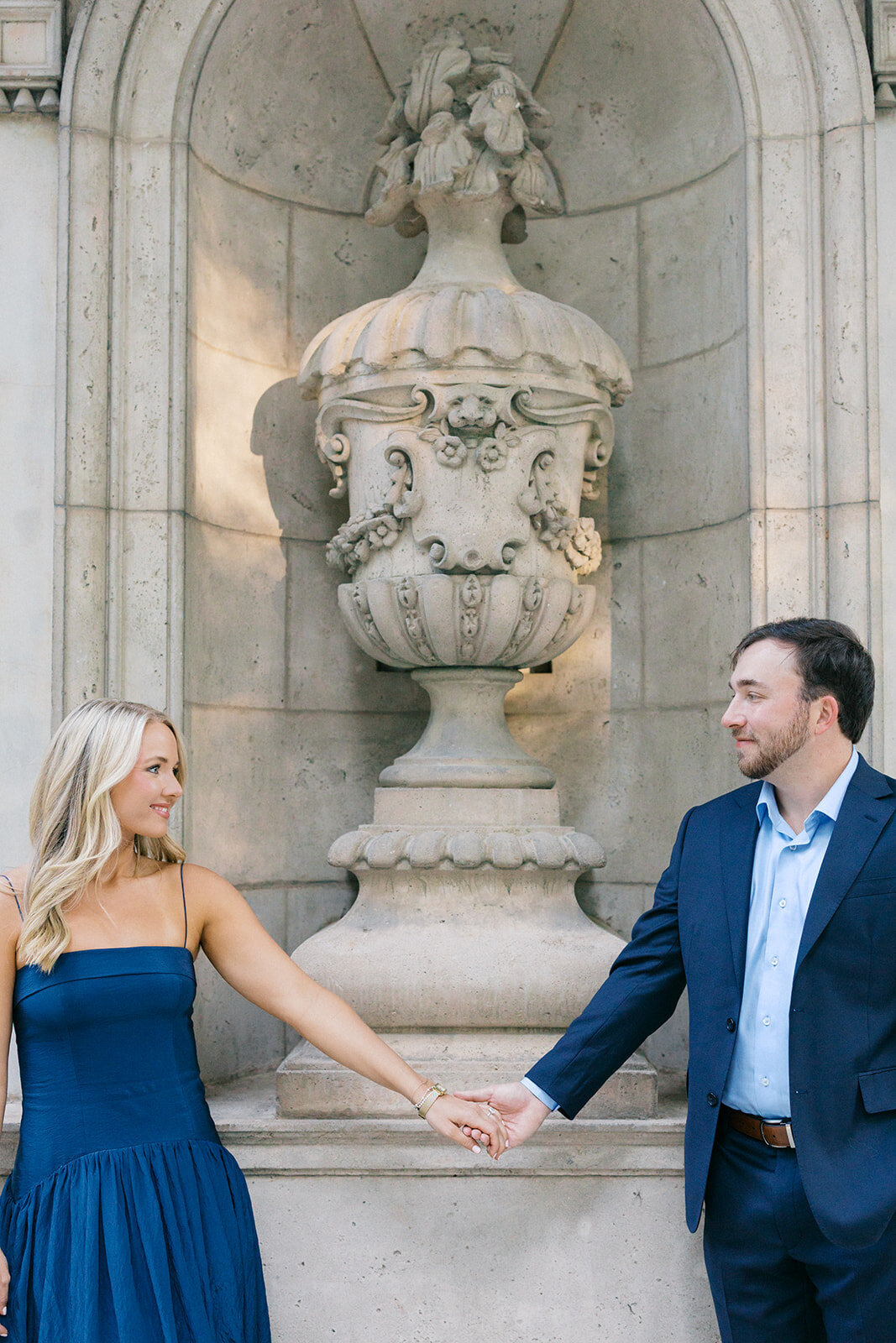Couple looks at each other in front of statue at the Atlanta History Center's Swan House