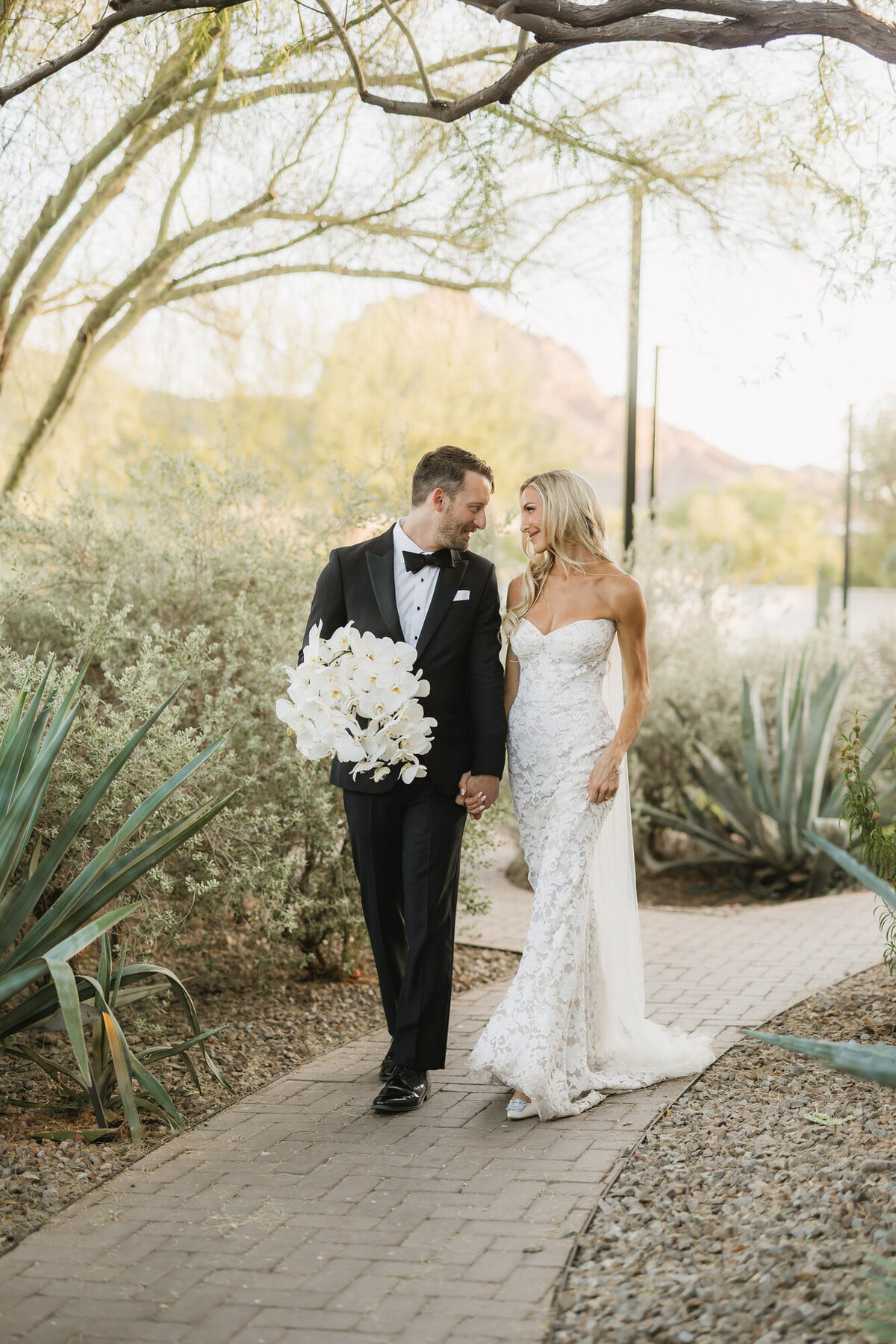 Bride and groom holding hands walking together