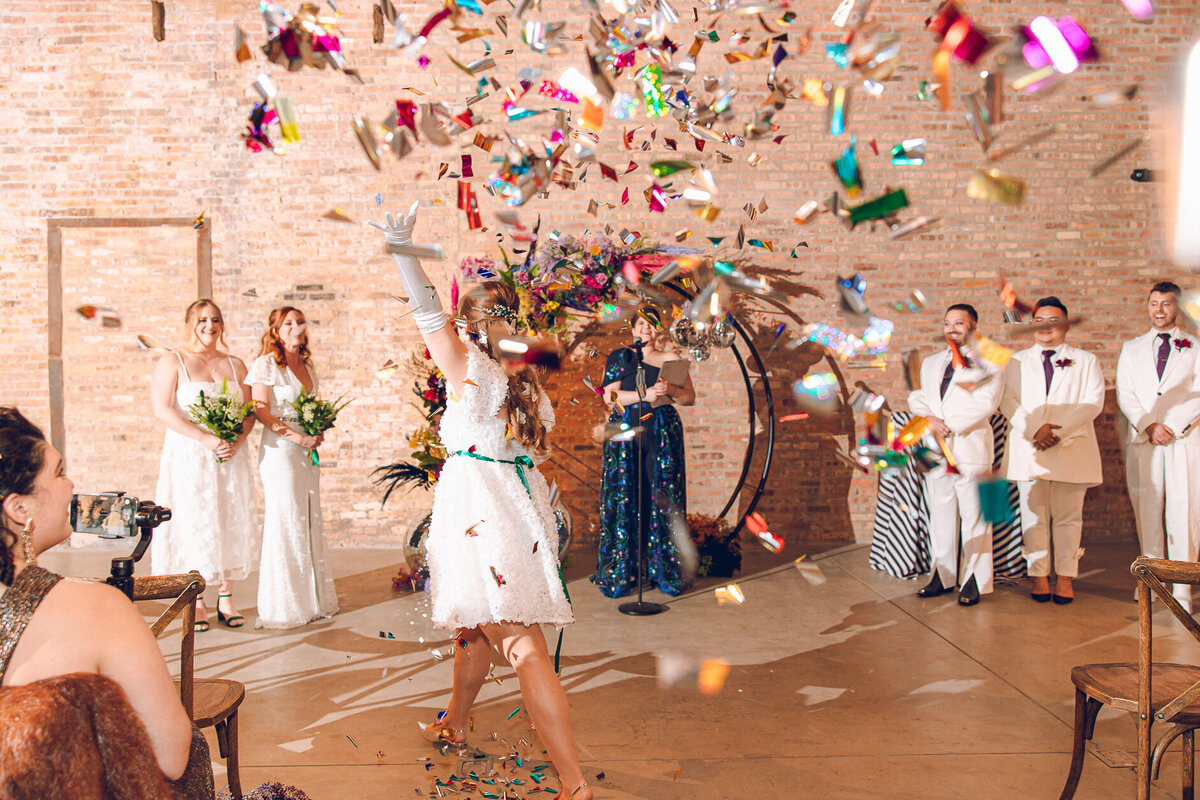 A bridesmaid throws confetti at a wedding at Wildman BT in Chicago