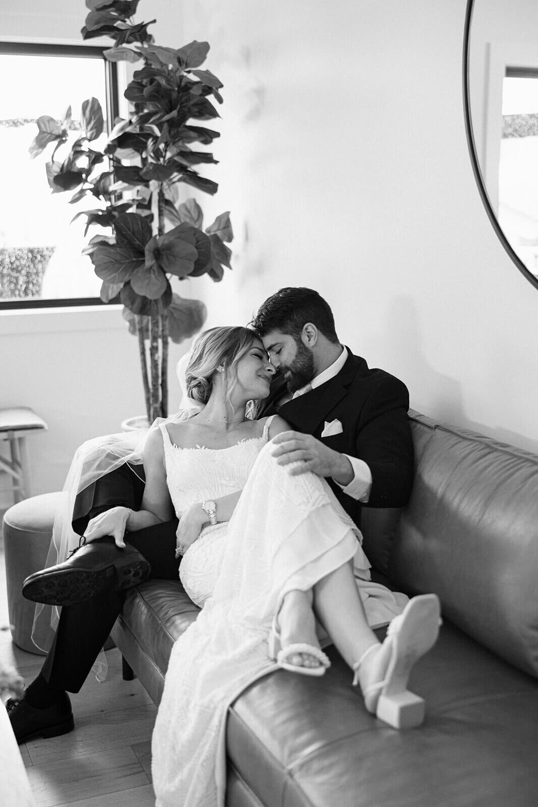 Bride and groom relaxing on sofa