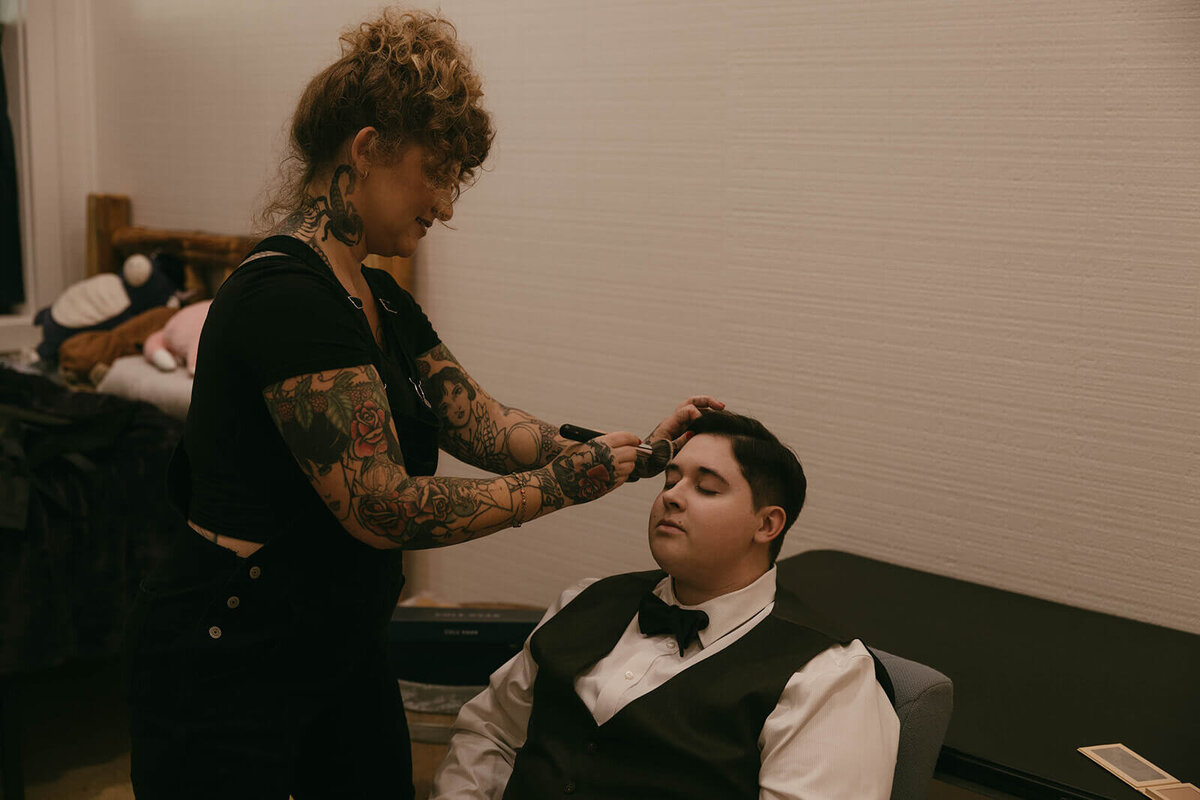 A bride getting her makeup done before her outdoor Oregon wedding.