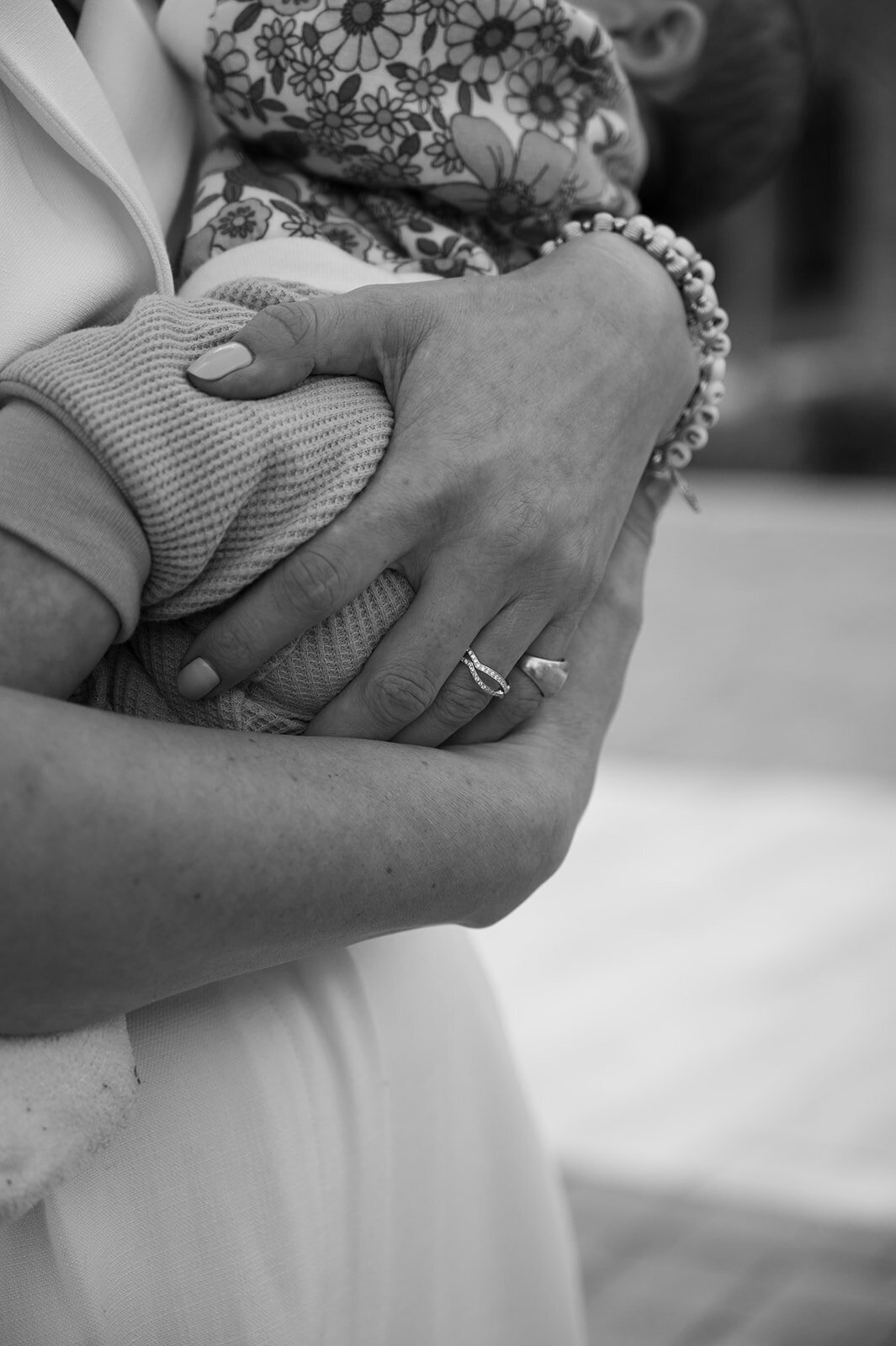 A close up of a woman's arms holding a baby.