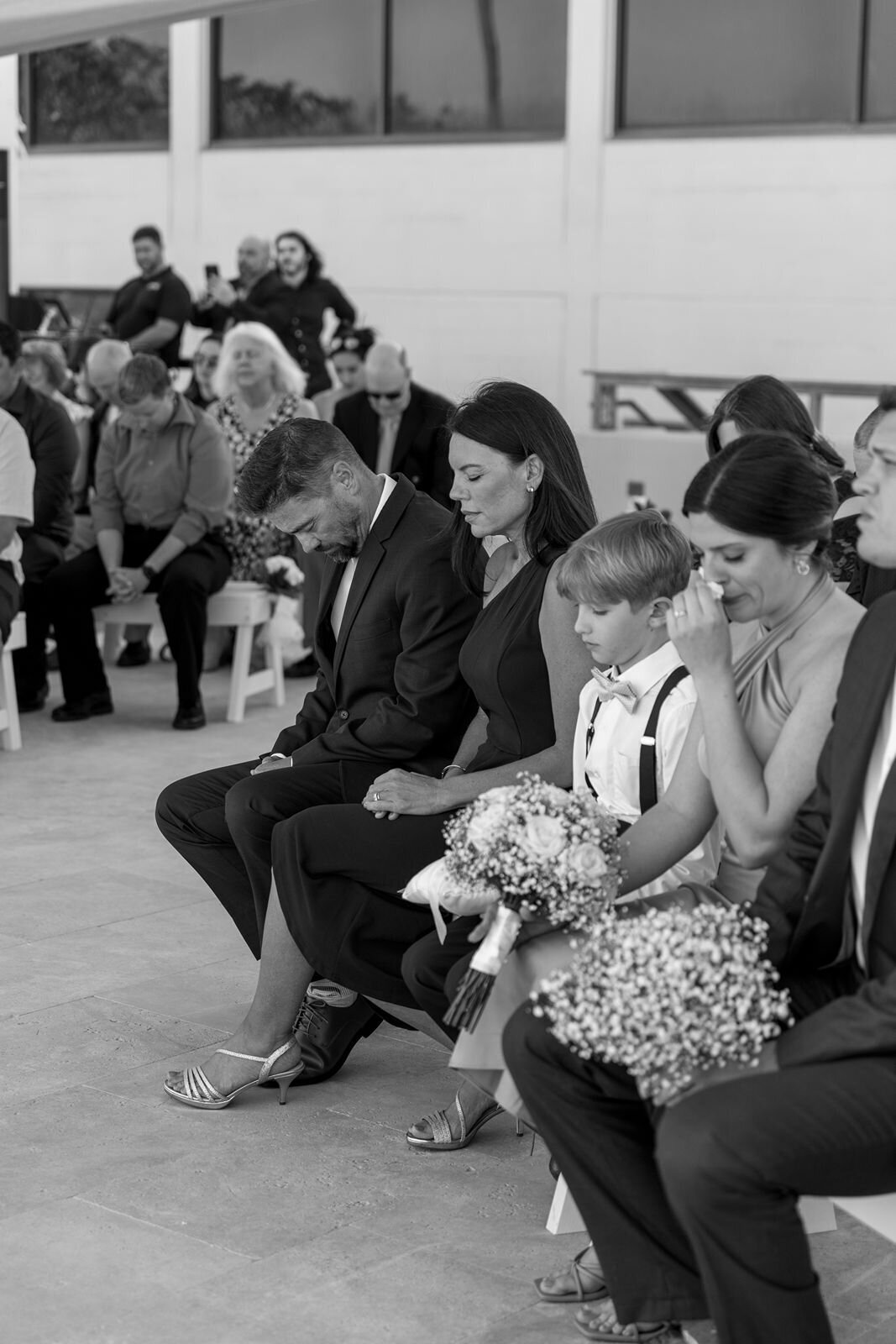 grooms family praying and emotional during the ceremony