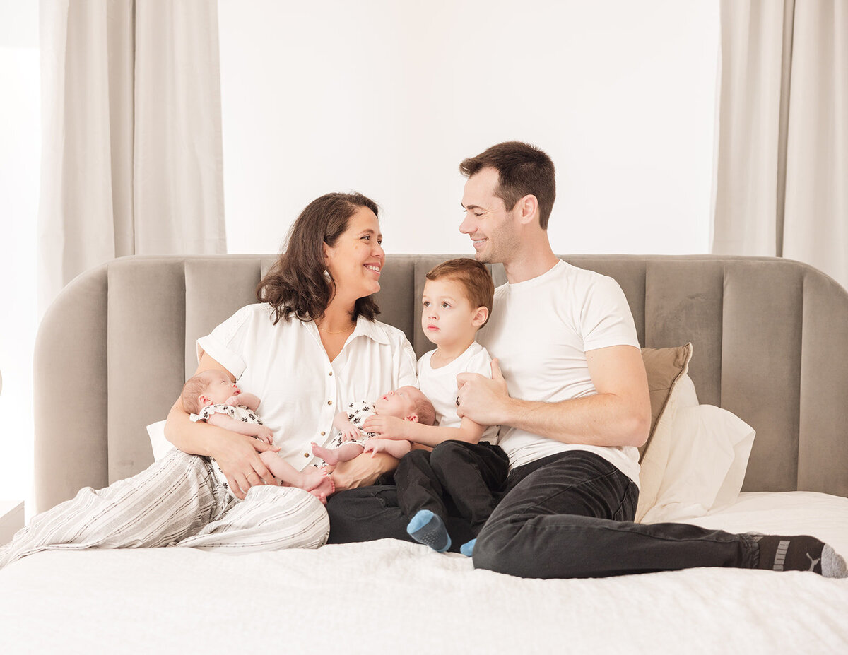 Mother holding newborn during in-home lifestyle photo session in Central Florida

