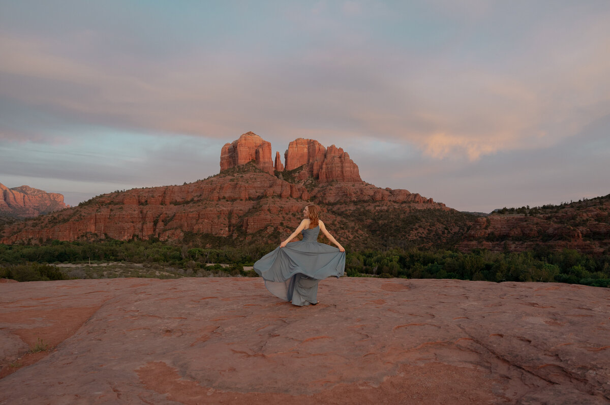 Couple standing against red rock backdrop during Sedona engagement session