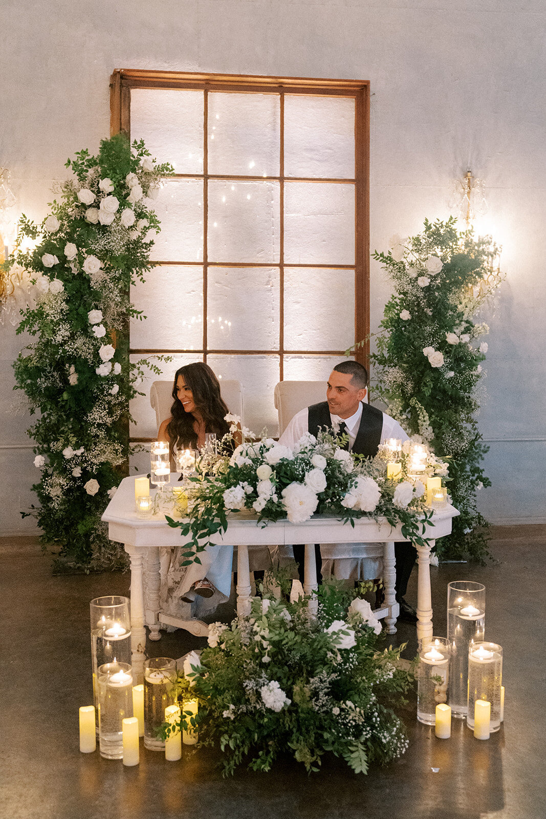sweetheart table flowers with candles at willow ballroom