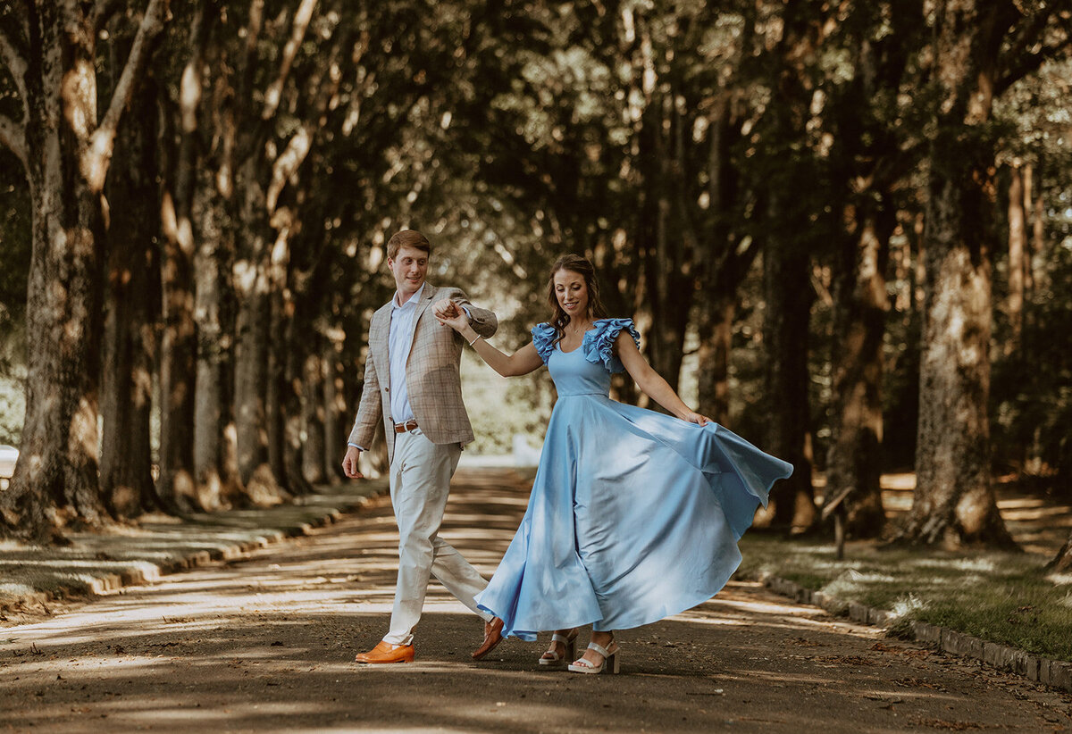 girl in blue dress dances with man at gate of opportunity in rome Georgia 