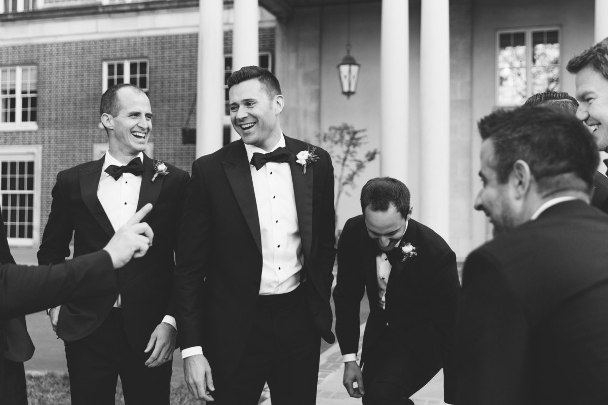 Groomsmen laugh in a real, candid moment captured by Atlanta's wedding photojournalist Rebecca Cerasani.