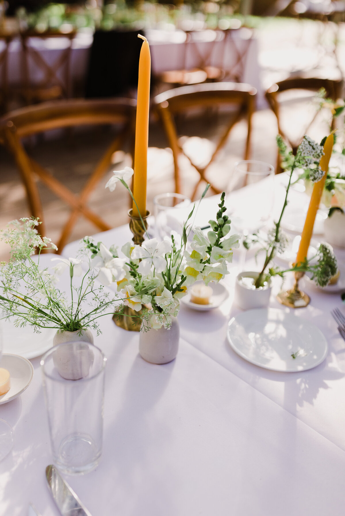 Wedding reception table with  white linen and white florals at Mattie's wedding venue in Austin