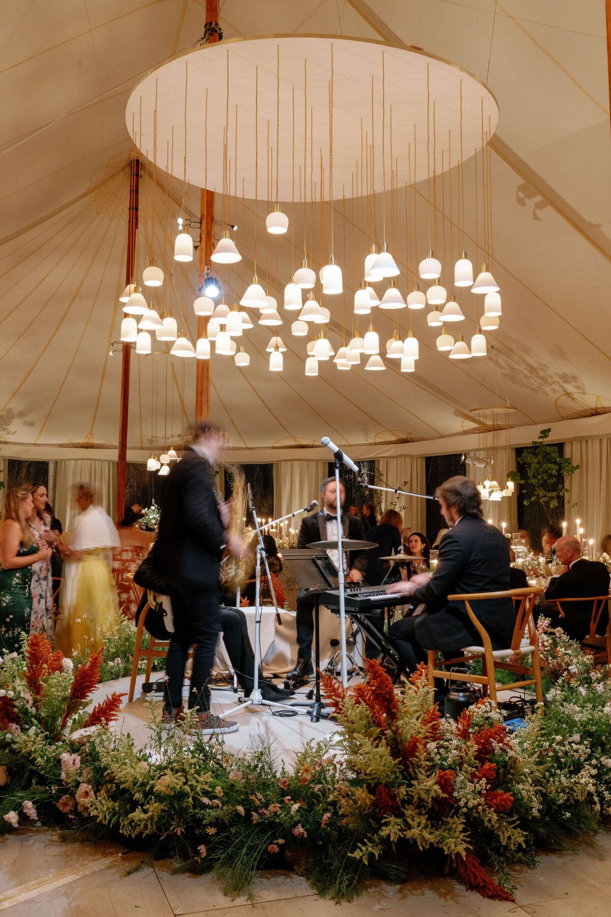 wedding band playing under chandelier
