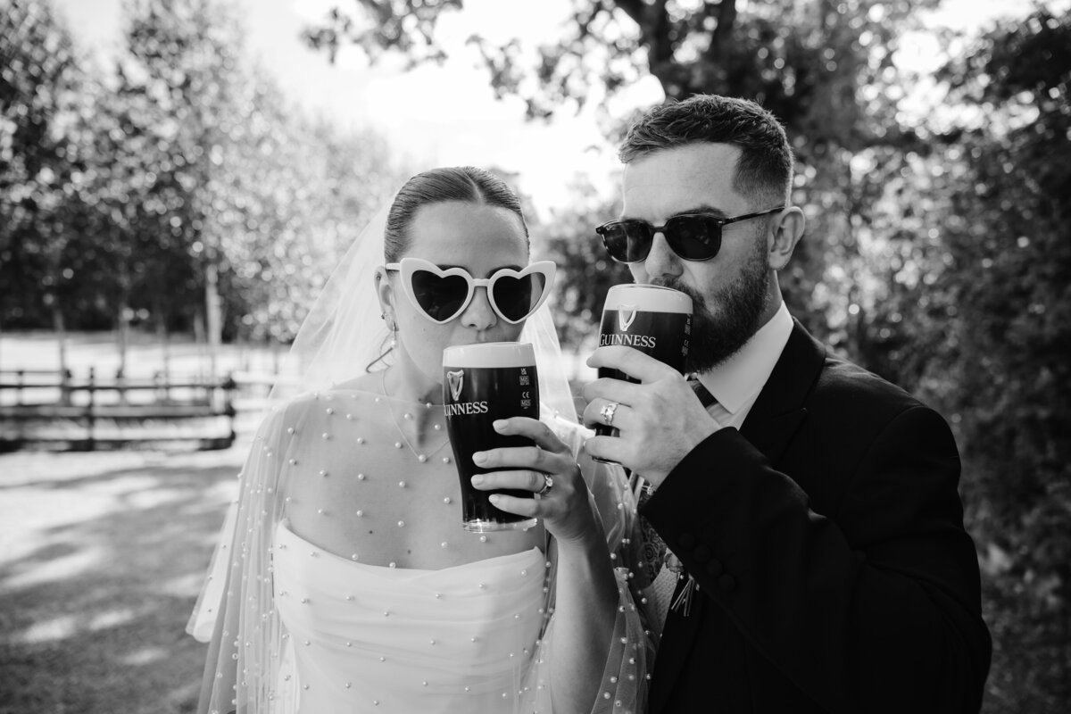 Bride and Groom drinking guiness in black and white