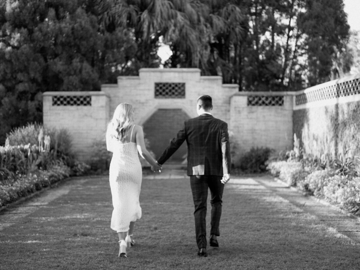Couple running together during their Charleston engagement session.