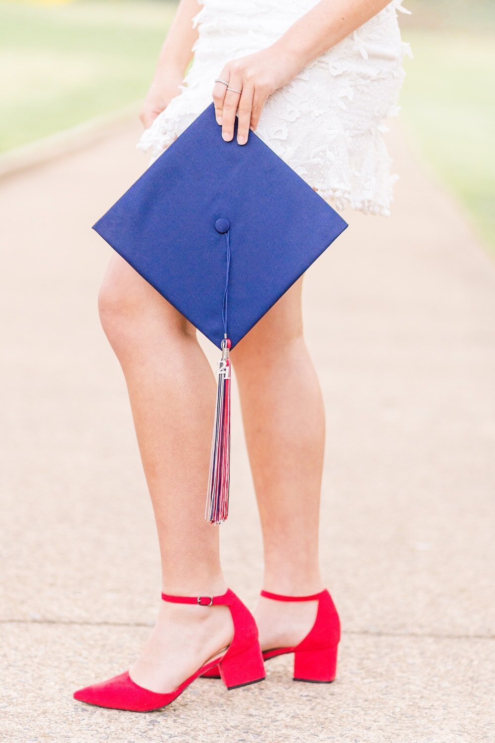 girl holding graduation cap during Prince William County, Virginia senior photos