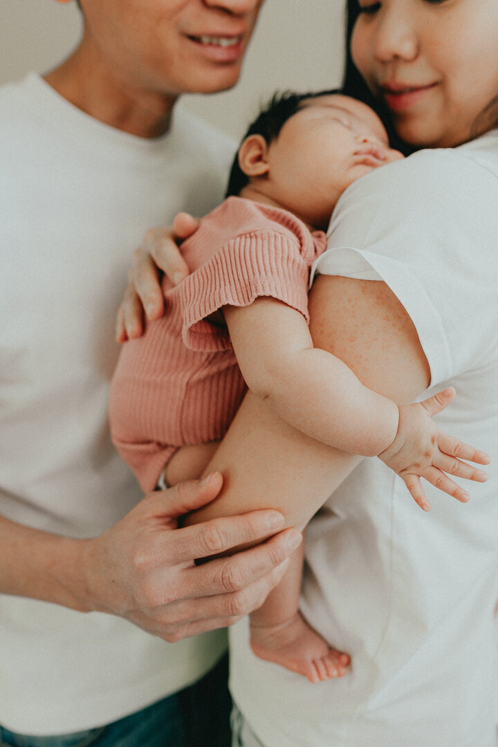 photo of mom and dad snunggling their newborn baby taken in langley