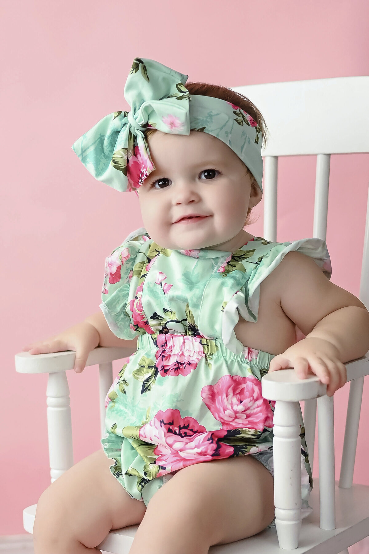 A girl with matching top and headband makes silly faces
