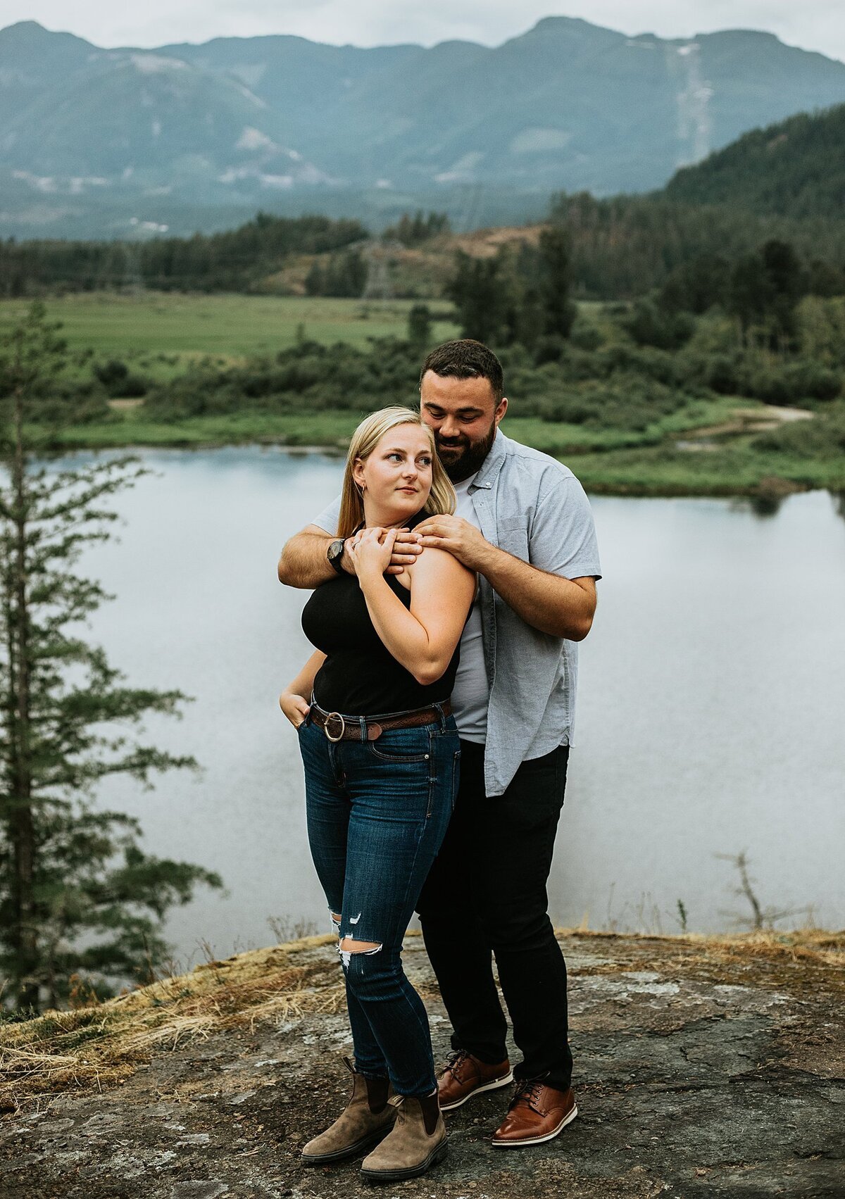 Couple in front of lake on rock