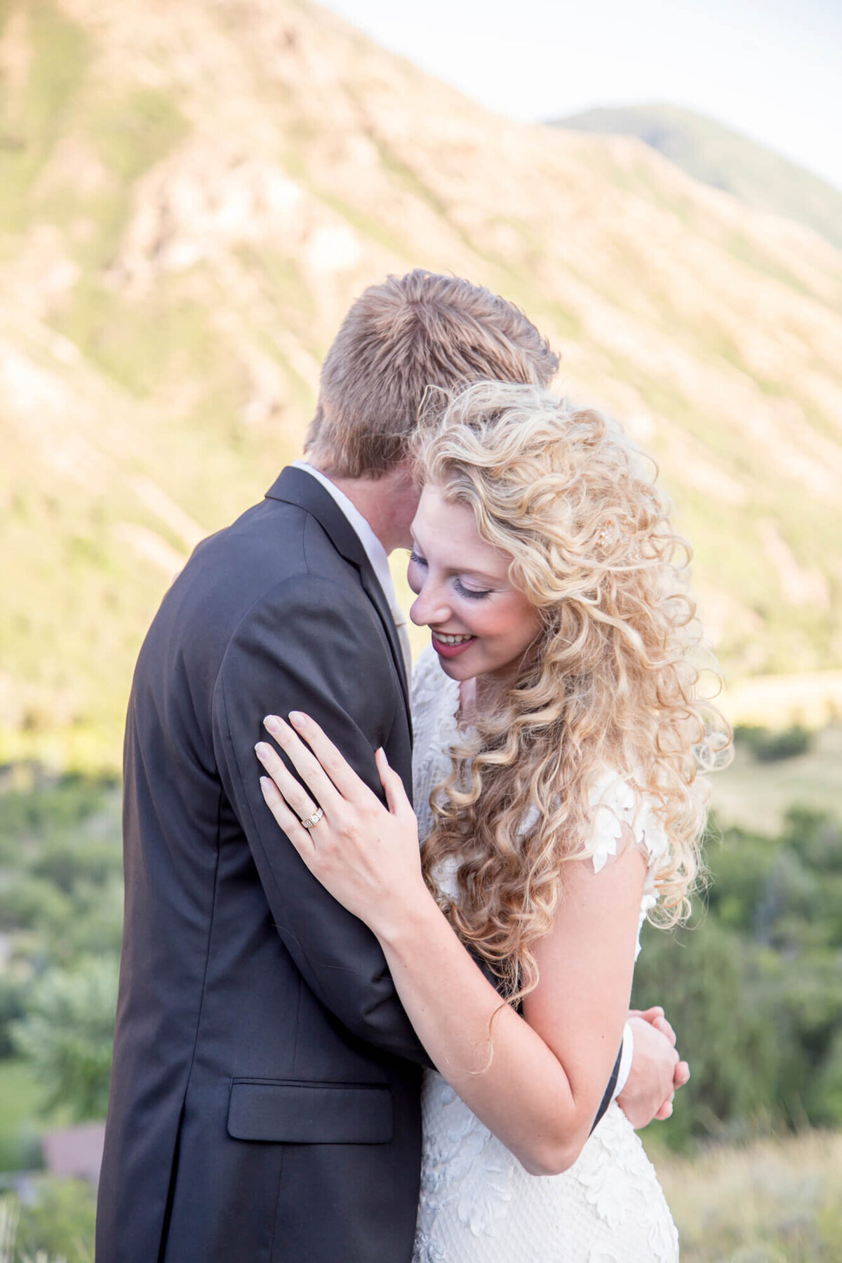 a bride laughing and hugging a groom