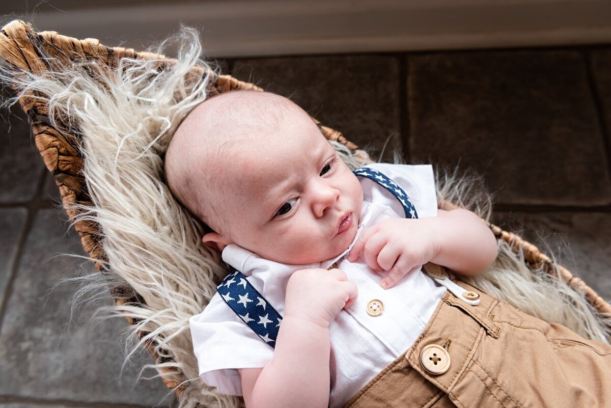 newborn boy in a basket