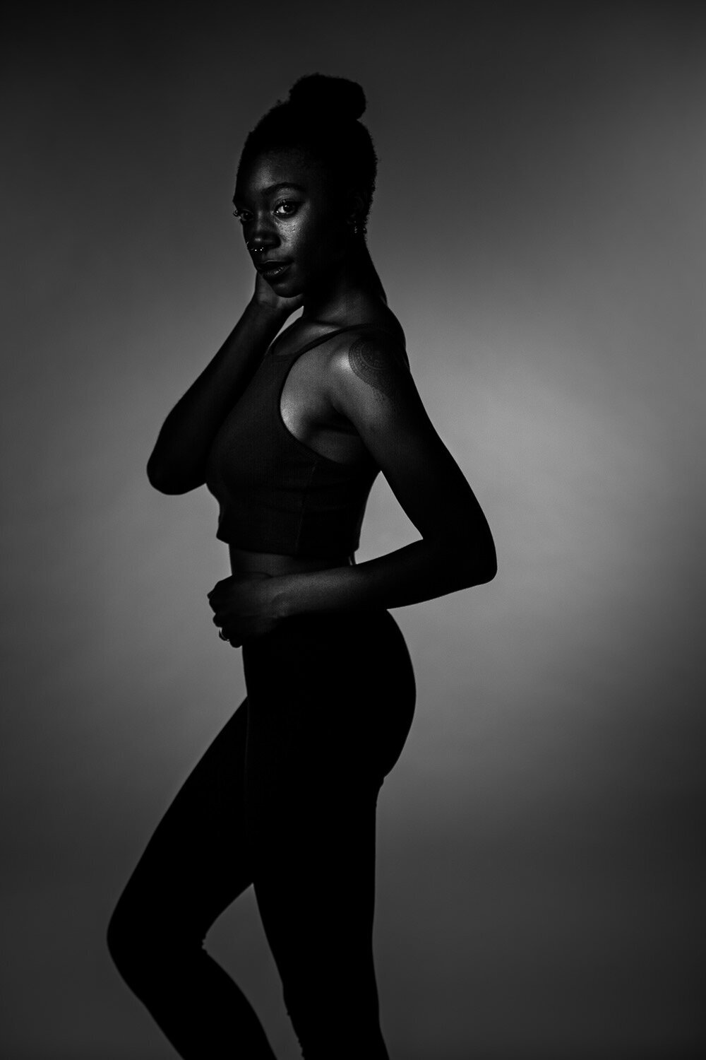 Dramatic, cinematic portrait of a personal trainer photographed in a studio for a high-impact branding image