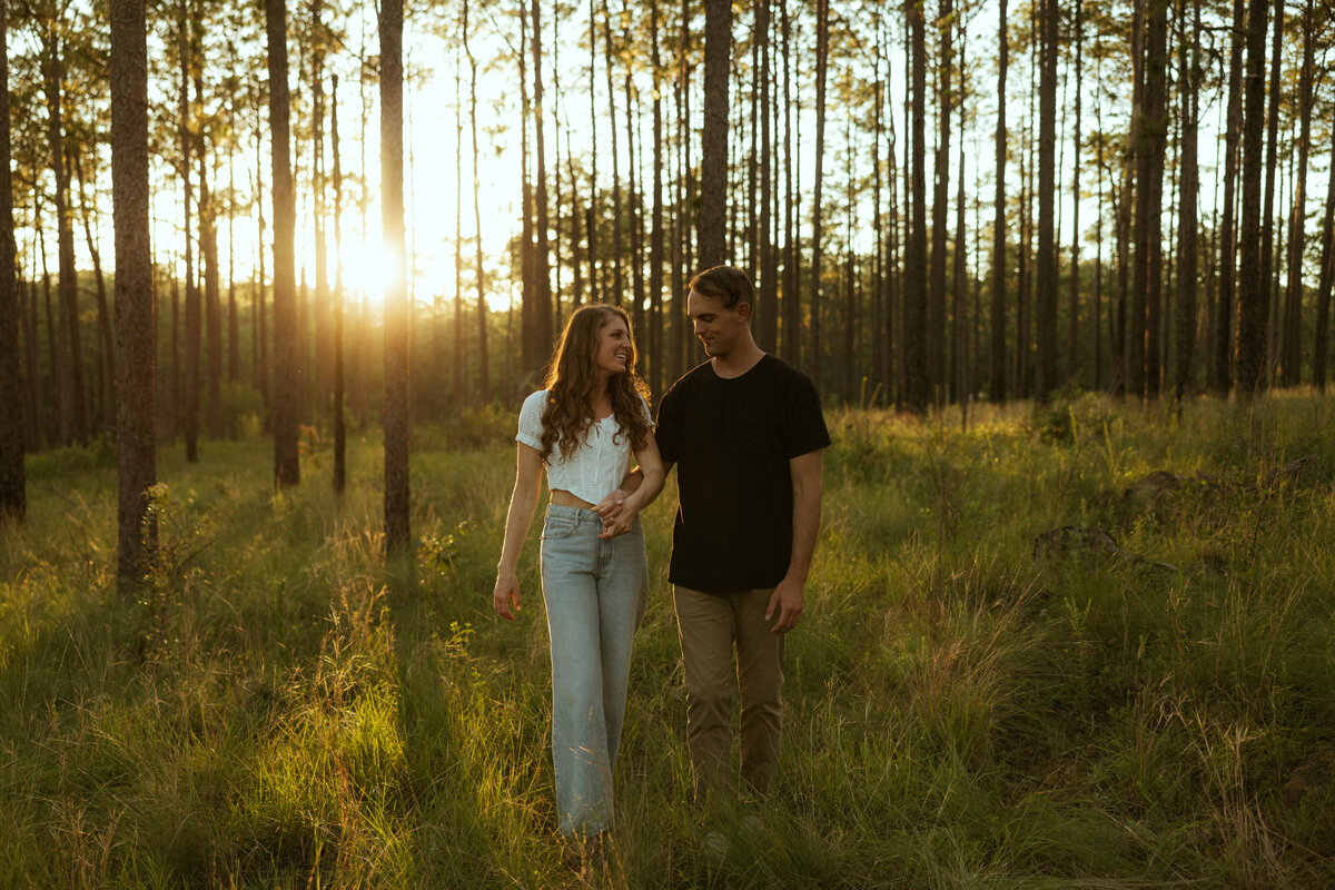 Couple posing for portraits in a forest.