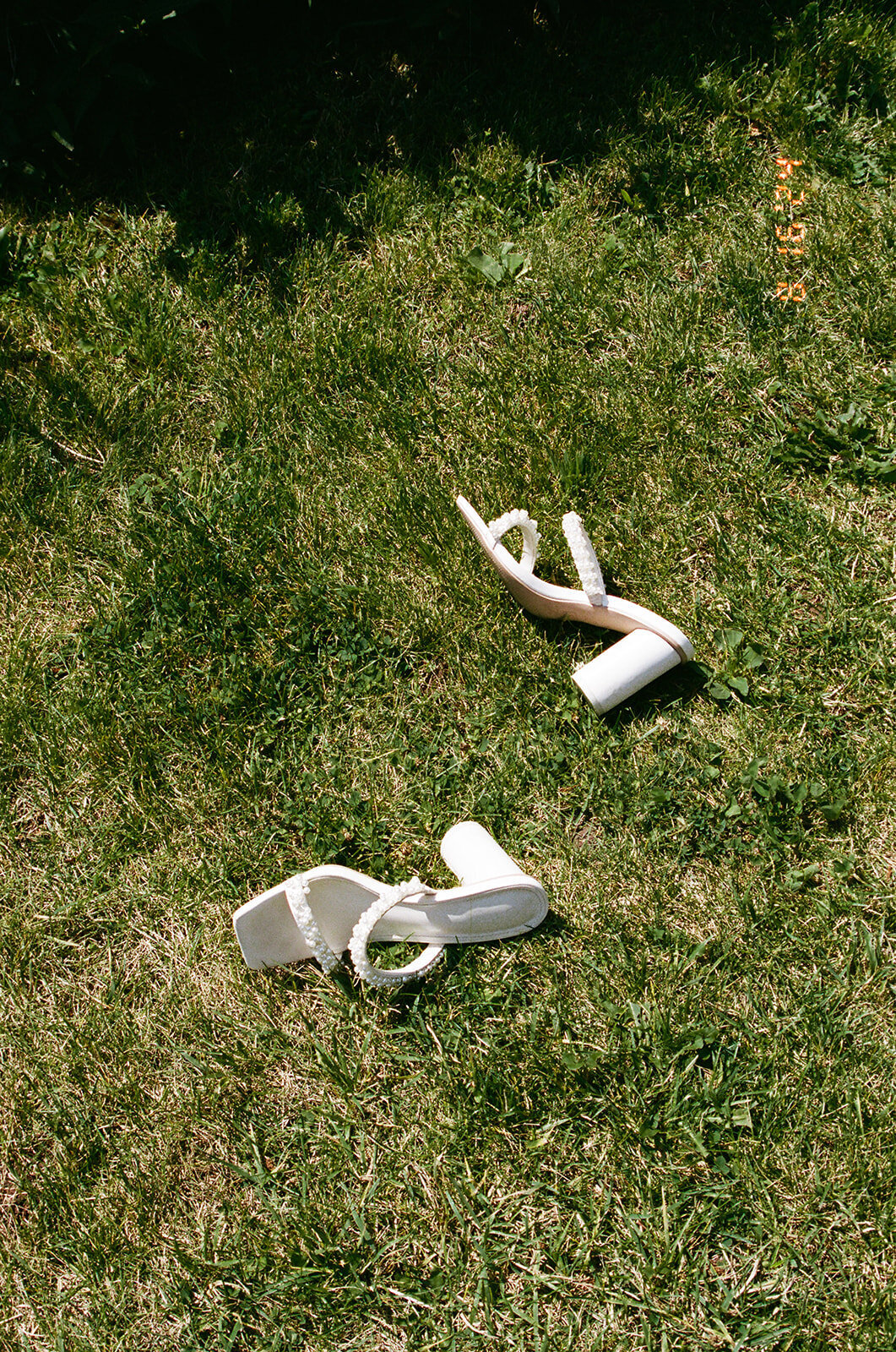 brides heels laying on the grass