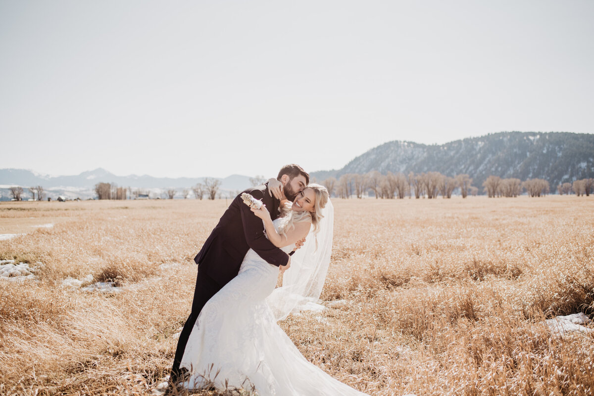 Jackson Hole Photographers capture bride and groom dip kiss during portraits