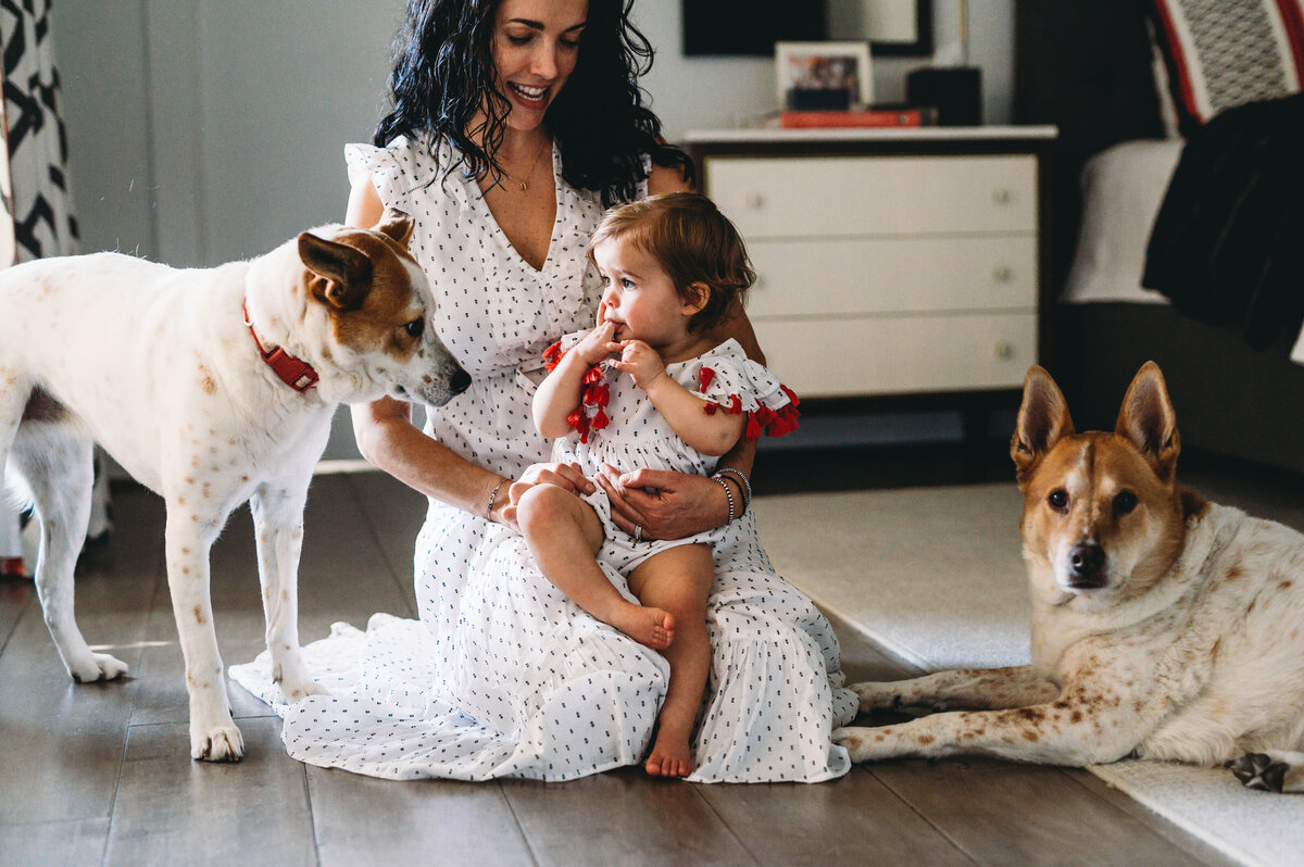 mother and daughter at home with two dogs