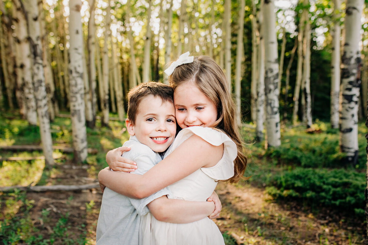 young kids smiling and hugging during family photos