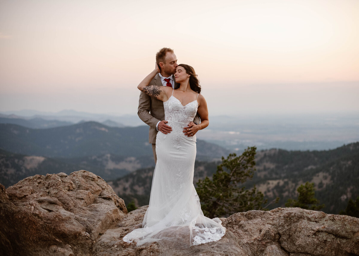 Couple embracing the colorado mountains during their wedding.