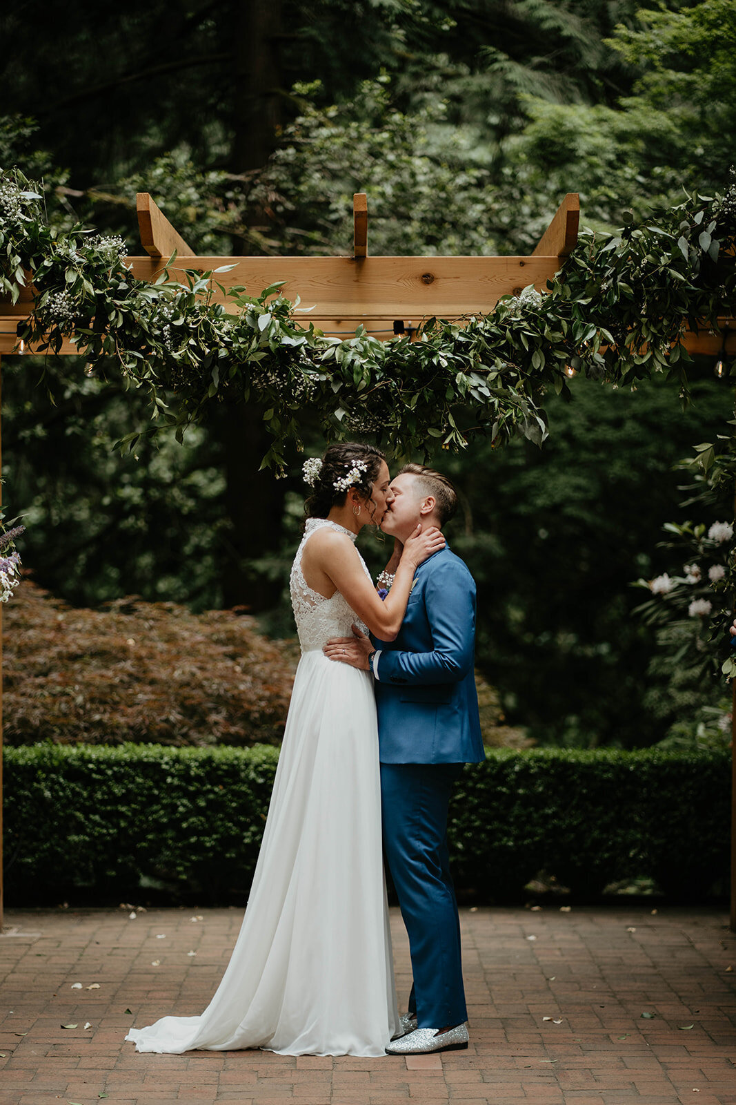 Bride and Bride sharing their first kiss after their ceremony at Leach Botanical Garden