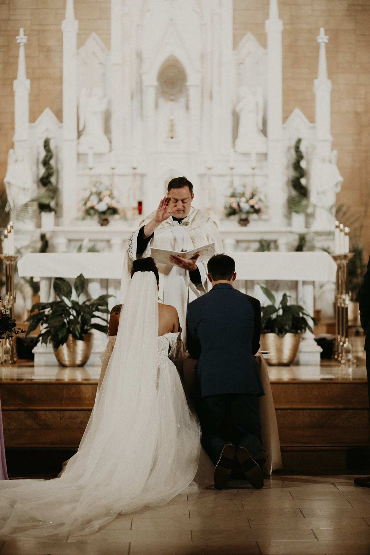 Elegant photo capturing a bride and groom during their beautiful Catholic wedding ceremony in Augusta, Georgia. Timeless moment of love and commitment in a picturesque church setting.