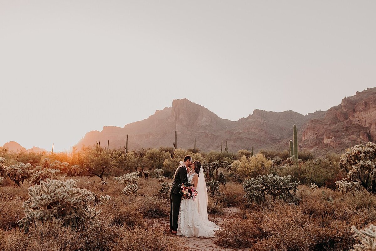 Bride and groom embrace at sunset in the Phoenix desert