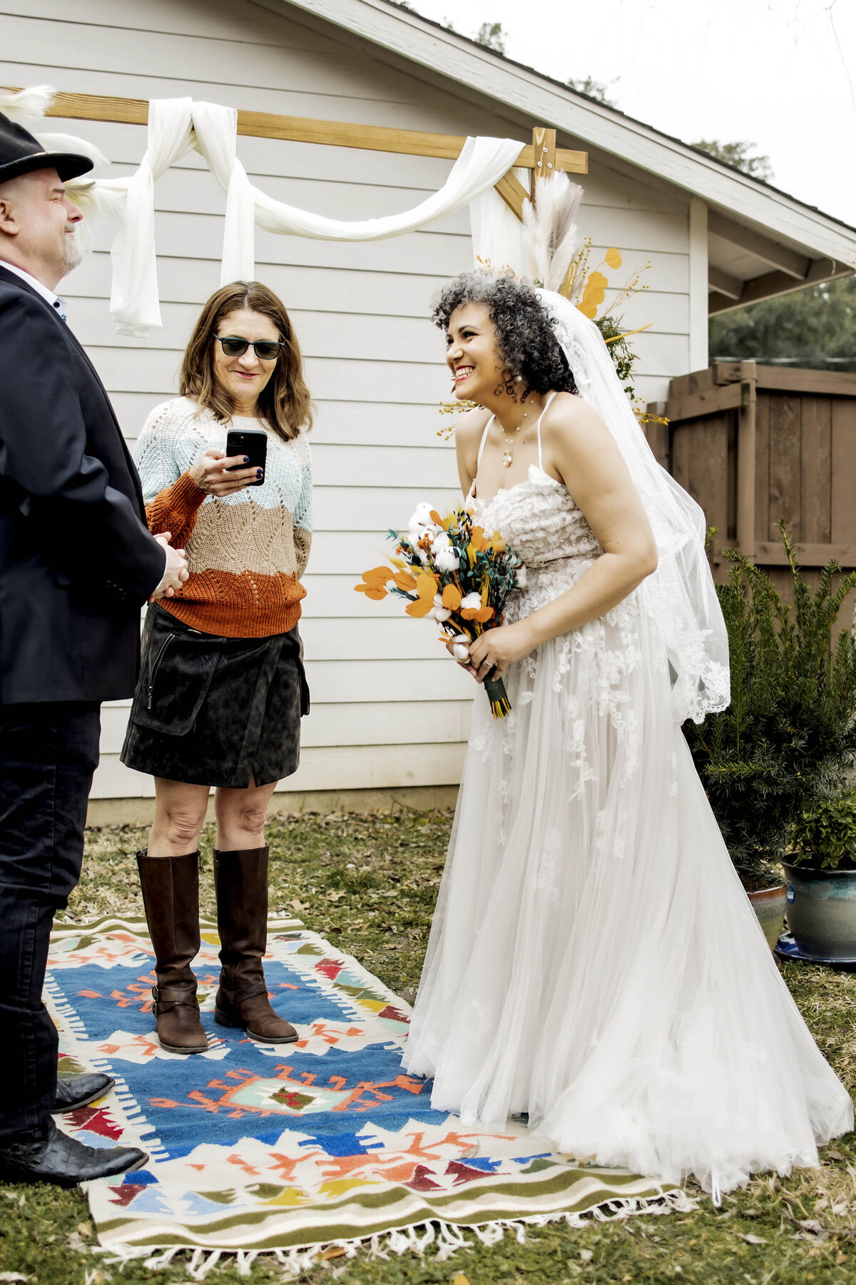 the bride and groom share a laugh during the ceremony