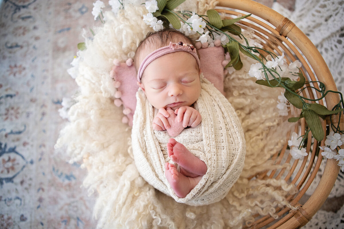 wrapped newborn with hands and feet out