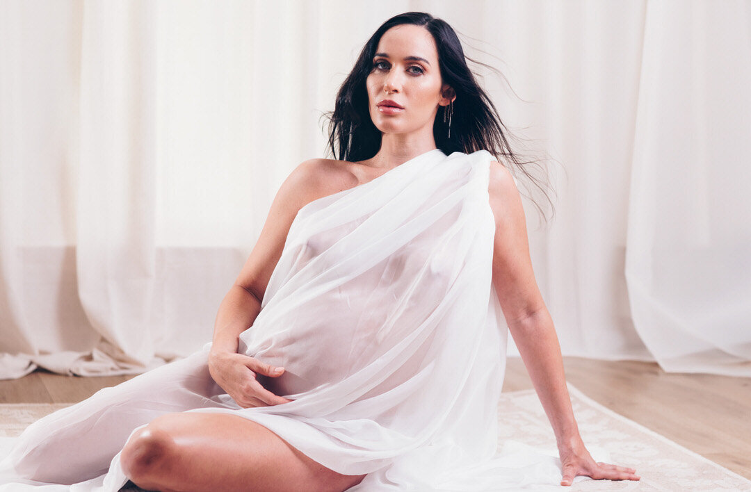 maternity photoshoot with sheet white fabric over body