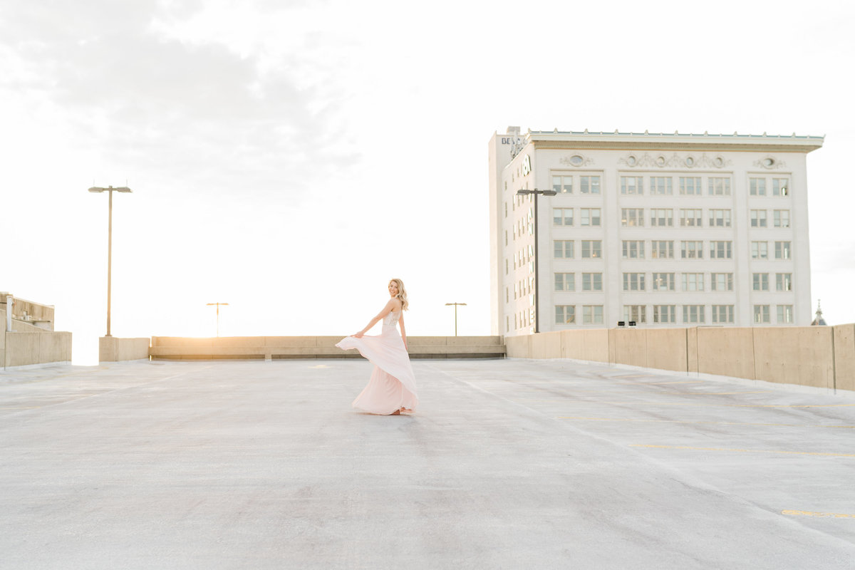 Woman in a pink dress on a rooftop in Alabama