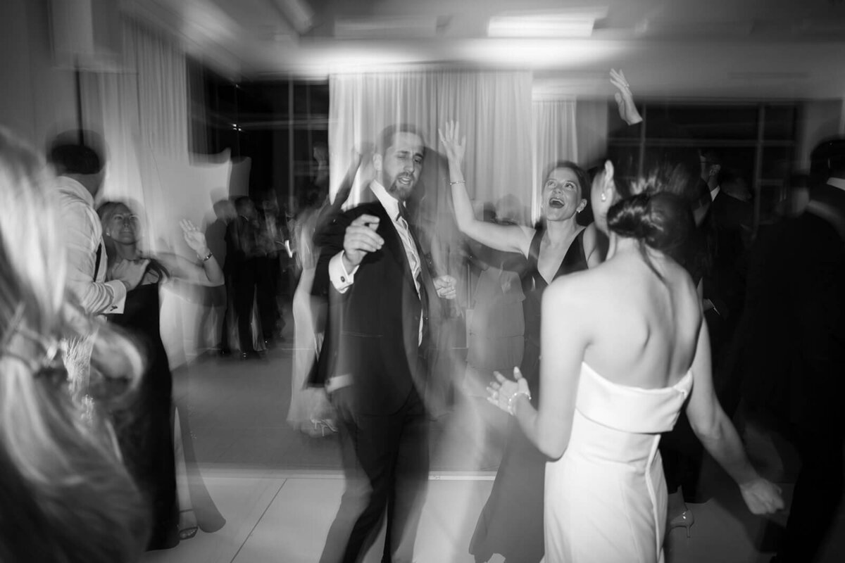 An artistically burred image of the bride an her guests at her Aspen Meadows Resort wedding reception showcases the fun and joy throughout the evening.