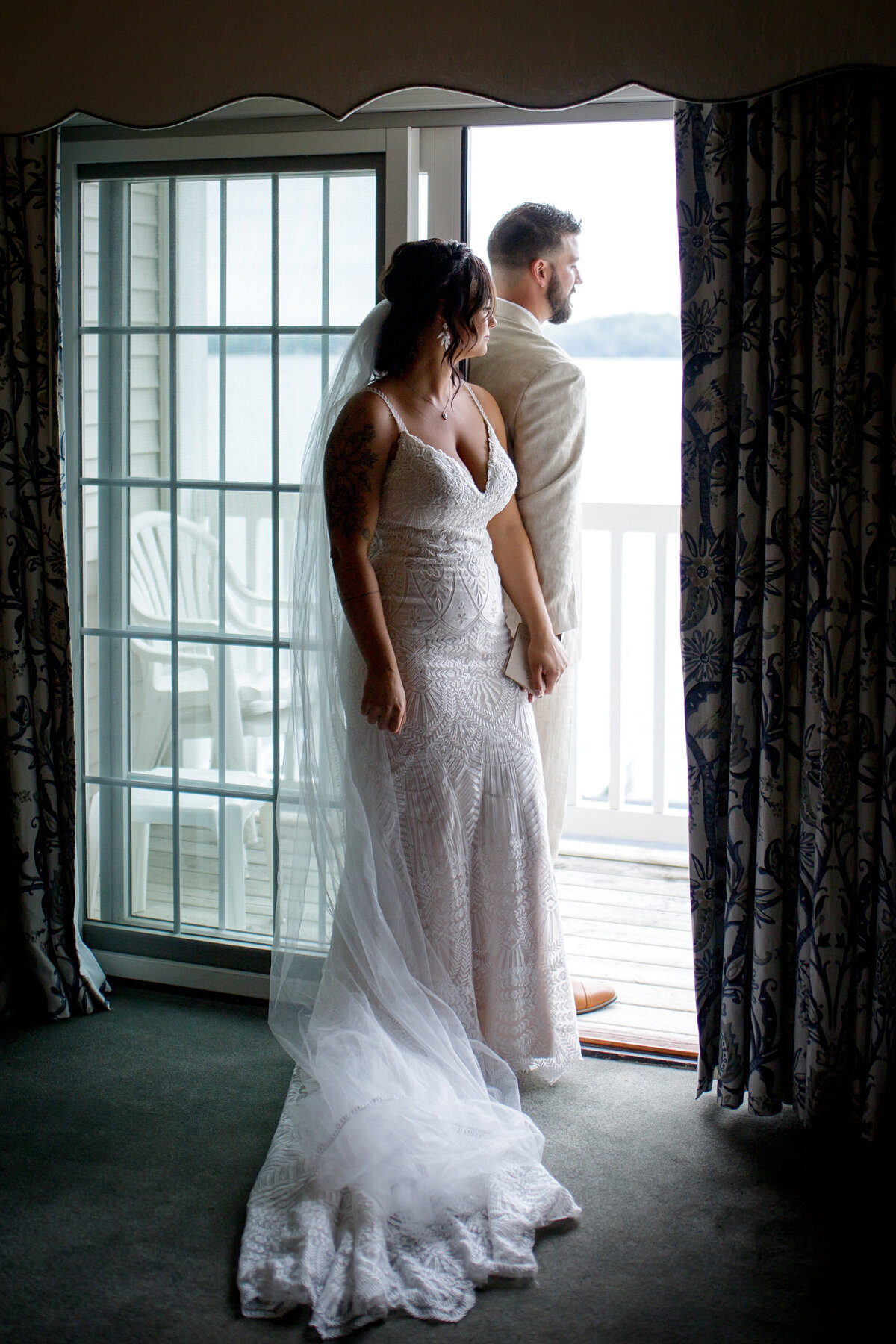 bride and groom at window