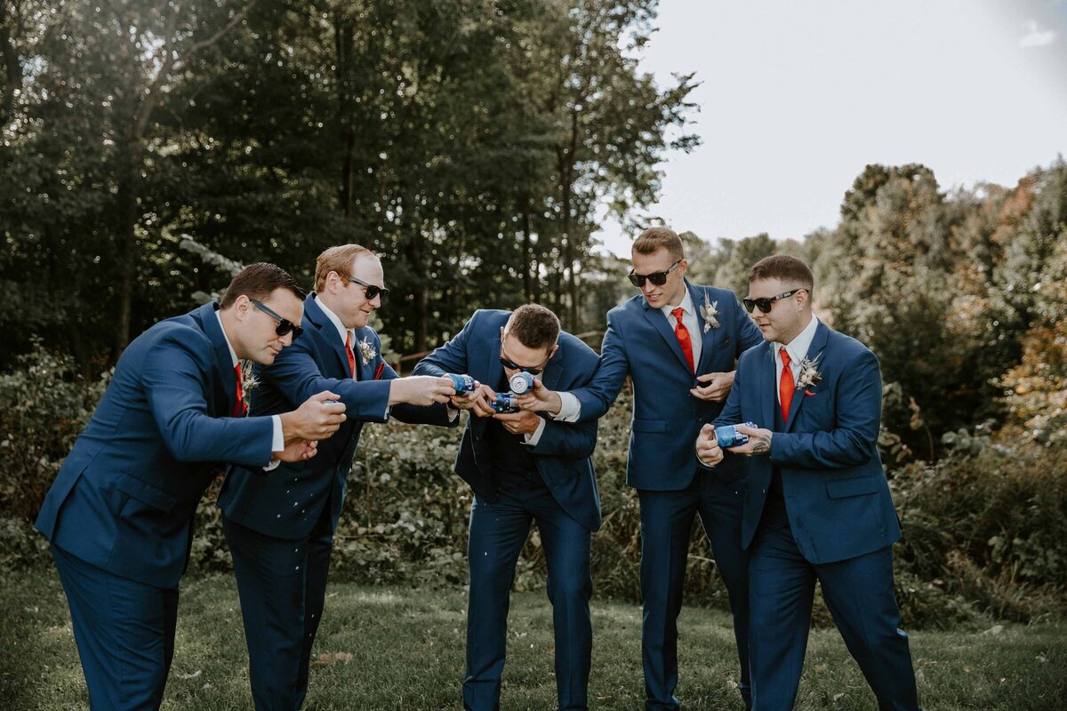 Groom and his groomsmen in Exeter, Ontario drinking beer for a candid and fun photo.
