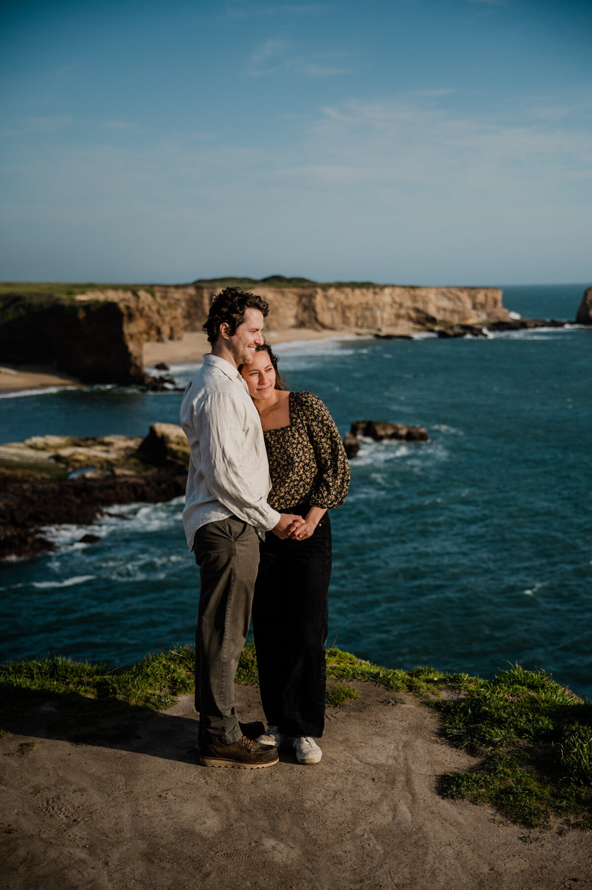 Engagement session on a cliffside in Santa Cruz, with stunning ocean views and dramatic scenery.