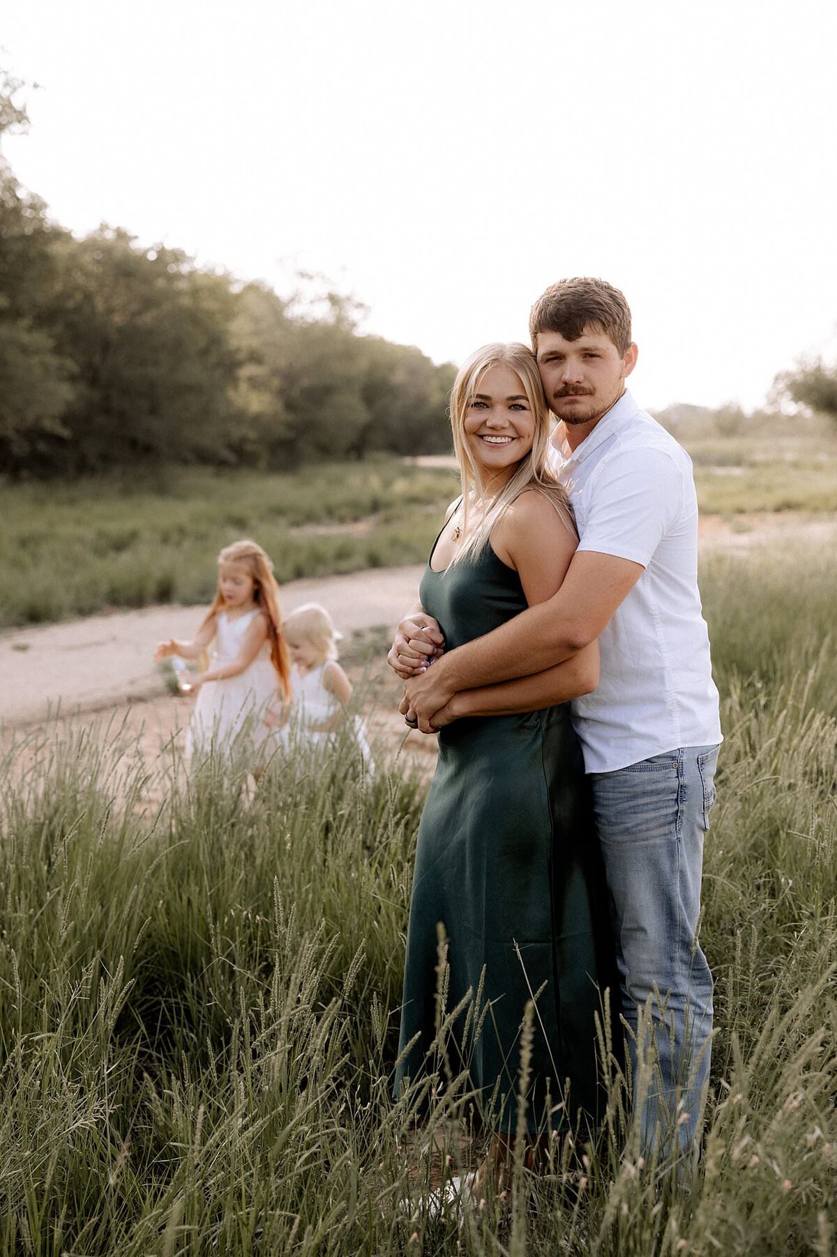 family of four in a field, photo captured by Mary Wiebe Photography a Lubbock family photographer