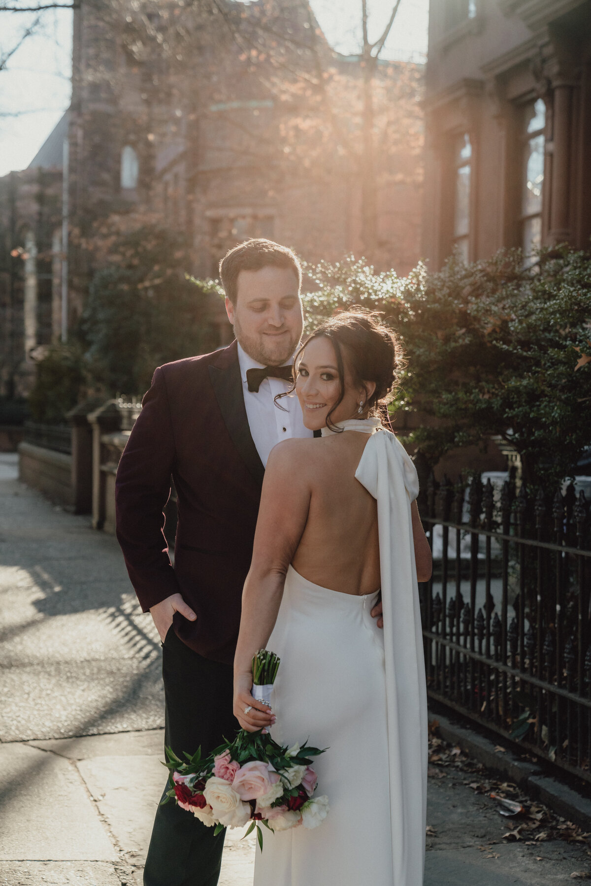 bride and groom pose outside in brooklyn