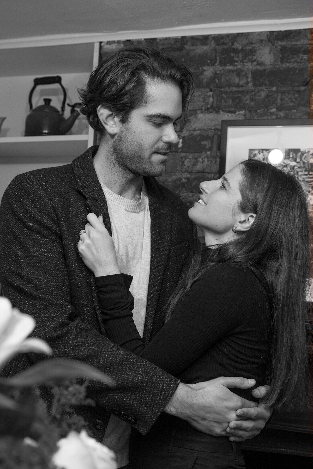Couple looking at each other lovingly in their living home.