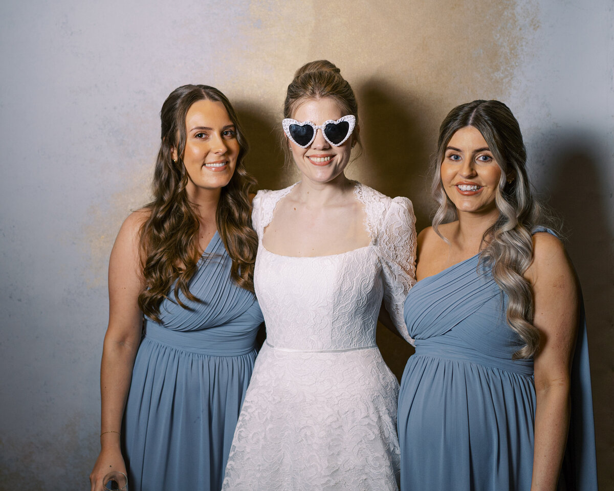 Bride and bridesmaids in wedding portrait studio wedding photobooth