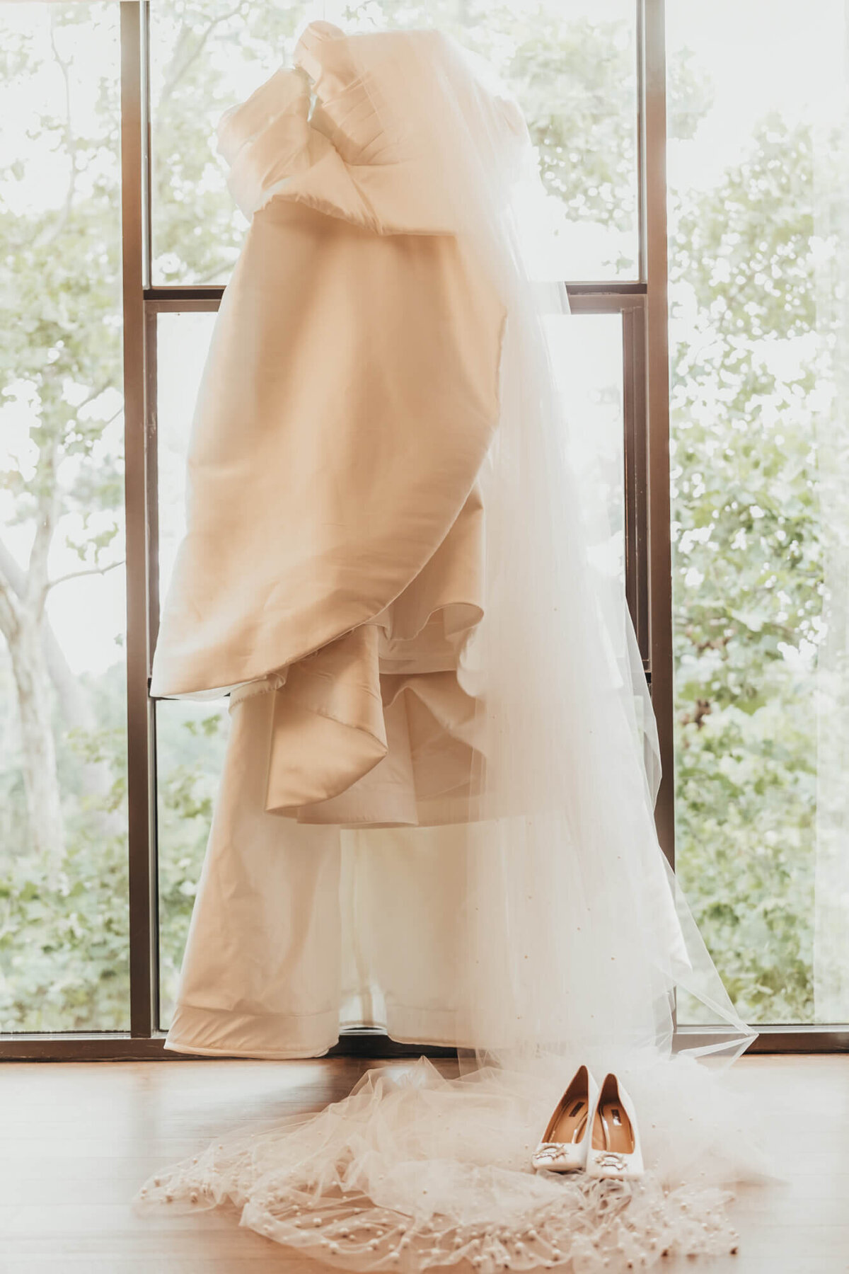 dress image against a wall of windows looking into trees at the Houstonian