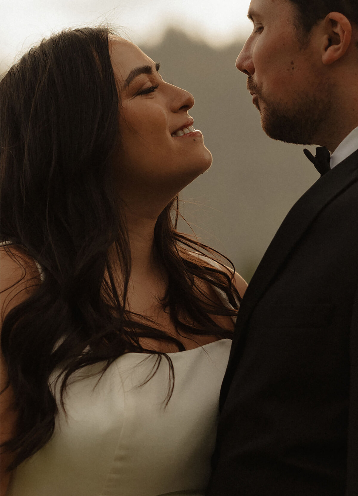 bride smiles lovingly at the groom as they embrace each other and celebrate their wedding in Bend, Oregon